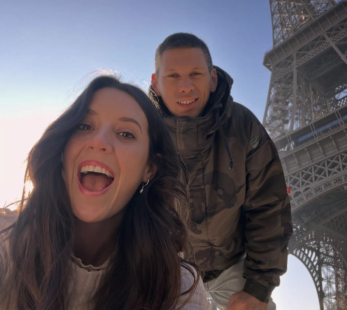 Melanie and her partner at the Eiffel Tower in Paris